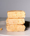 Stacked pieces of Lemke Marzipan Heavenly Grace on a white plate background