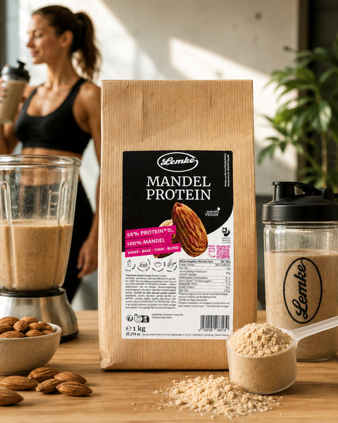 Lemke Mandel Protein 1 kg displayed with a freshly blended protein shake, shaker bottle, whole almonds, and almond protein powder in a fitness-inspired setting.