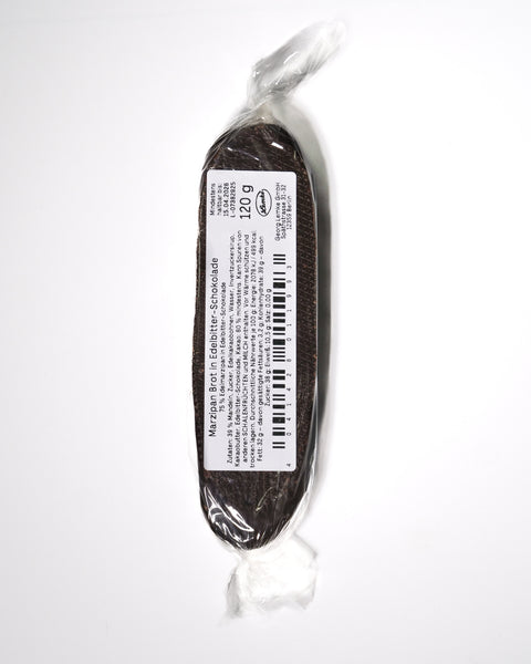 Wrapped marzipan loaf with a white product label on the back. The label shows the product name and weight of "120 g" on the dark chocolate covered bar.